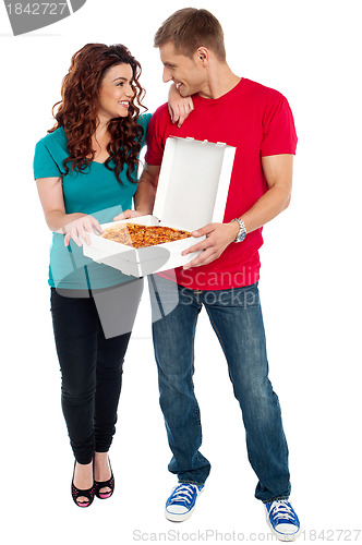 Image of Love couple sharing pizza. Enjoying together