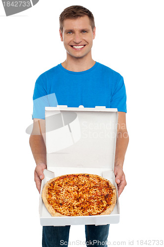 Image of Smiling man offering pizza to you