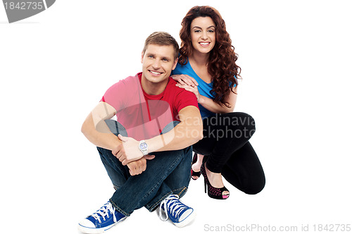 Image of Trendy adorable love couple sitting on floor