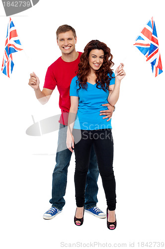 Image of Guy hugging his girlfriend and both holding UK flag