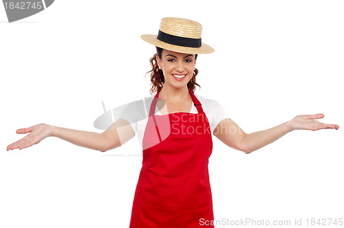 Image of Pretty chef welcoming you with her arms stretched