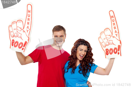 Image of Young couple showing boo hurray foam hand