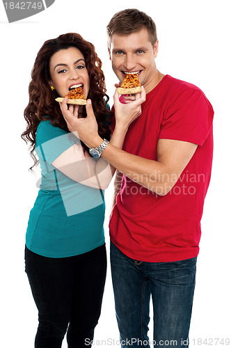 Image of Adorable love couple enjoying pizza pie together