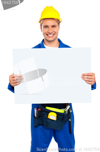 Image of Construction worker holding blank billboard