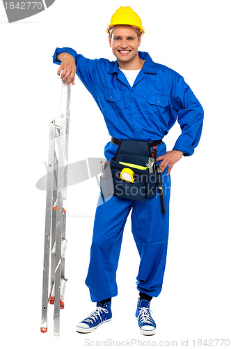 Image of Industrial contractor resting hand on stepladder