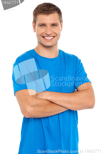 Image of Casual portrait of smiling man posing with arms crossed
