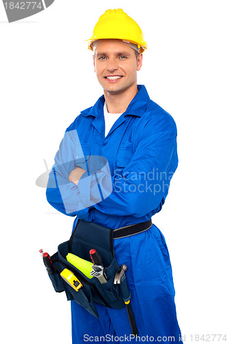 Image of Young contractor with tool set and arms crossed