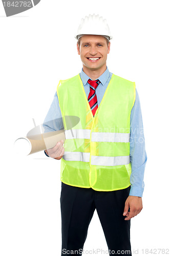 Image of Happy male architect holding blueprints