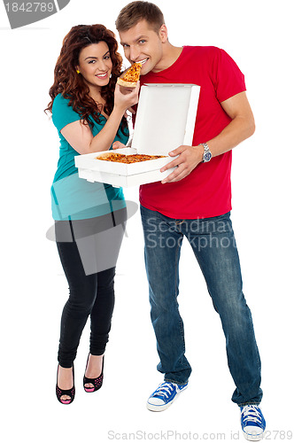 Image of Couple enjoying pizza together, great bonding