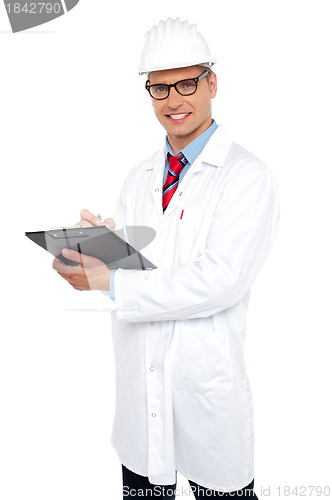 Image of Engineer preparing report looking at you