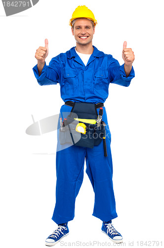 Image of Successful young worker gesturing double thumbs up