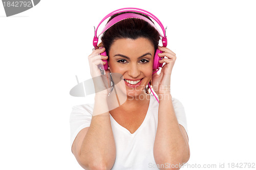 Image of Young brunette enjoying music