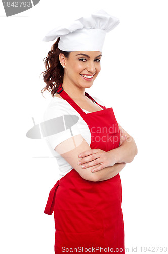 Image of Side view of cheerful chef posing casually