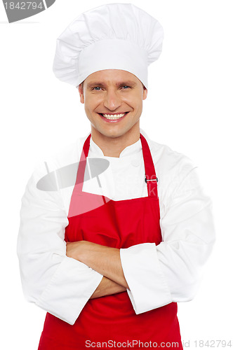 Image of Portrait of a smiling chef with arms crossed