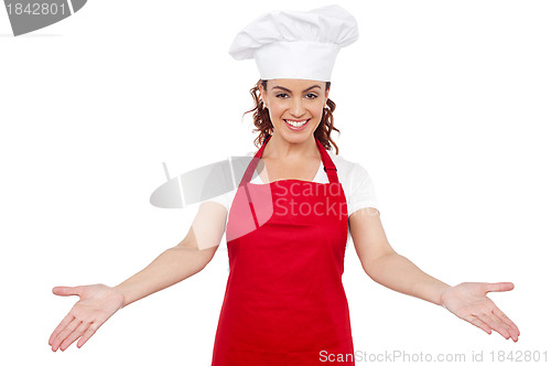 Image of Smiling woman chef welcoming you