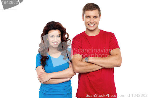 Image of Attractive couple posing with arms crossed