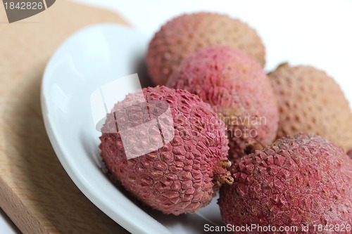 Image of fresh lychees on a porcelain plate