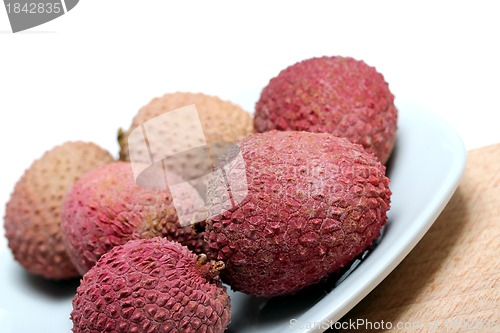 Image of fresh lychees on a porcelain plate