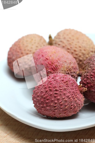 Image of fresh lychees on a porcelain plate