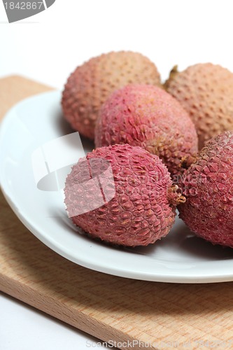 Image of fresh lychees on a porcelain plate