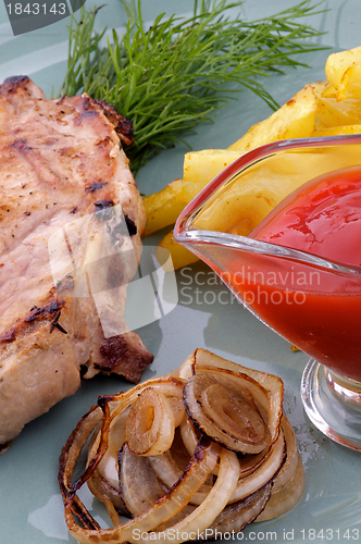 Image of Pork Steak with French Fries and Grilled Onions