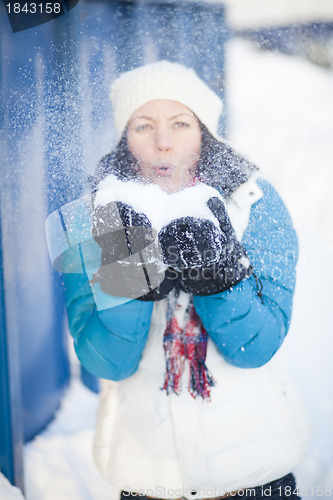 Image of Woman blowing snow