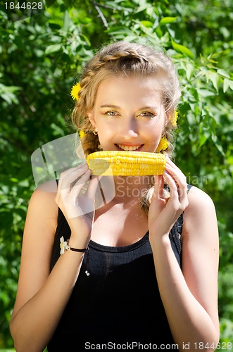 Image of woman eating corn-cob