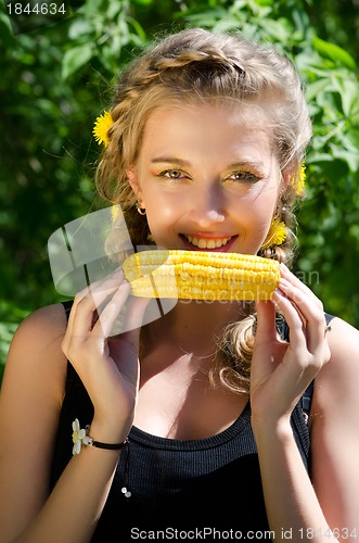 Image of woman eating corn-cob