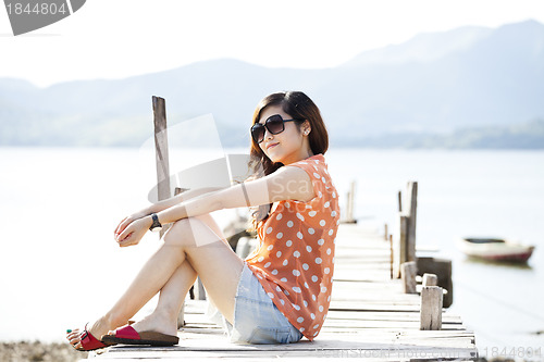 Image of Asian woman on the wooden bridge