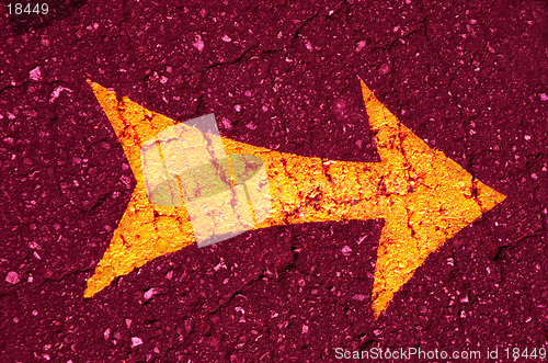 Image of orange arrow on the pink  asphalt