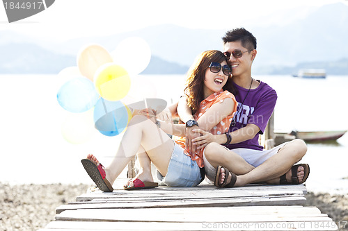 Image of Asian couple on wooden bridge