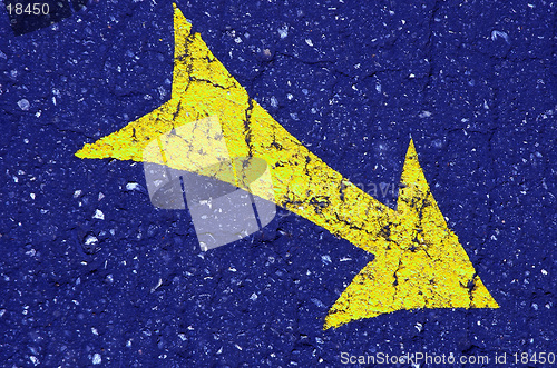 Image of yellow arrow on the blue asphalt