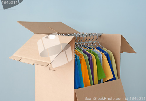 Image of Multicolored clothes in a wardrobe box for easy moving