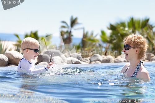 Image of mother and son splashing