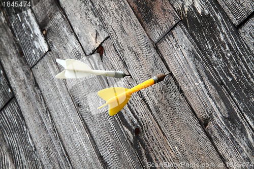 Image of darts in the wooden background