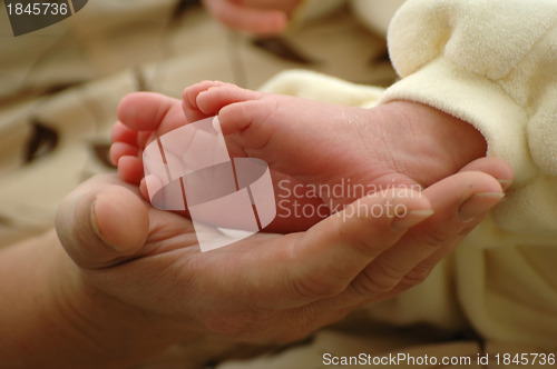 Image of Mother holding her newborn's foot
