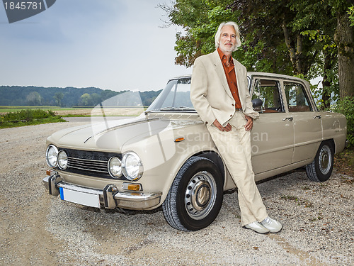 Image of man in front of his car