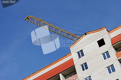 Image of Crane boom over building