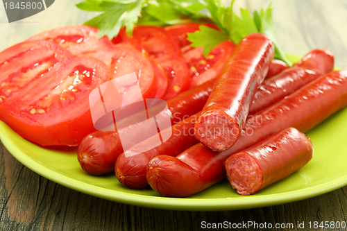 Image of Smoked sausage and tomatoes.