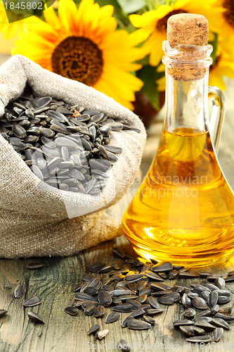 Image of Sunflower seeds in bag and bottle of oil.