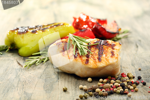Image of Turkey steak with rosemary and baked peppers.