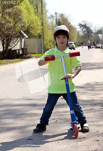 Image of little boy with a scooter