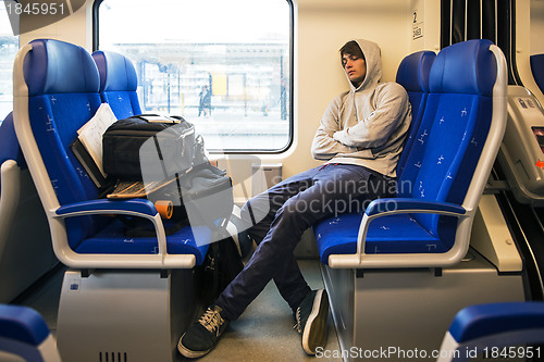 Image of Young Man Sleeping In Train