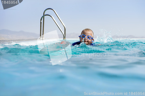 Image of Boy Swimming In an Infinity Pool 