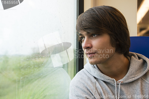 Image of Young Man Travelling In Train