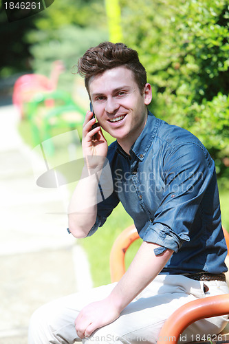 Image of Russian man in park with telephone