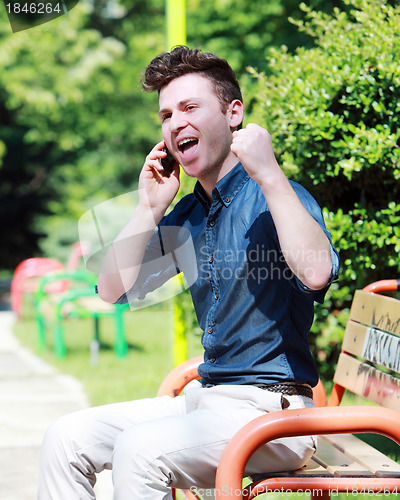 Image of Happy young man on telephone