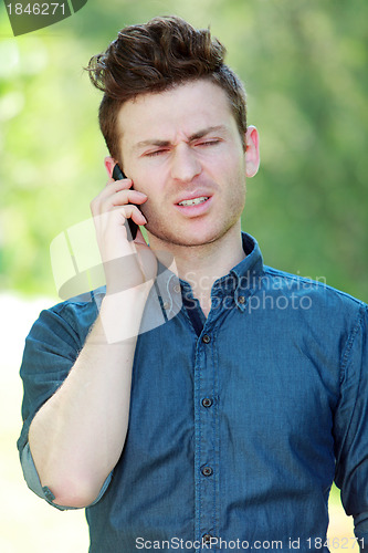 Image of Disappointed young man at telephone