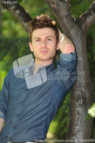 Image of Portrait of handsome man in park