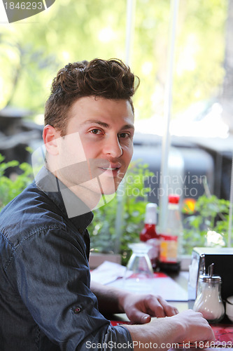 Image of Young man at restaurant